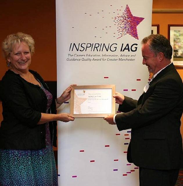 John McGrath, Assistant Head of Holy Family RC and CE College, receives its award from Wendy Cooke, Greater Manchester 14-19 Assistant Director 

