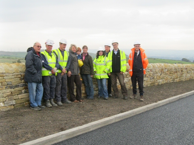 Residents, officers from the Impact Partnership, the Director of Bethel, members of the workforce and Councillor Metcalfe stood in front of the new wall. 
