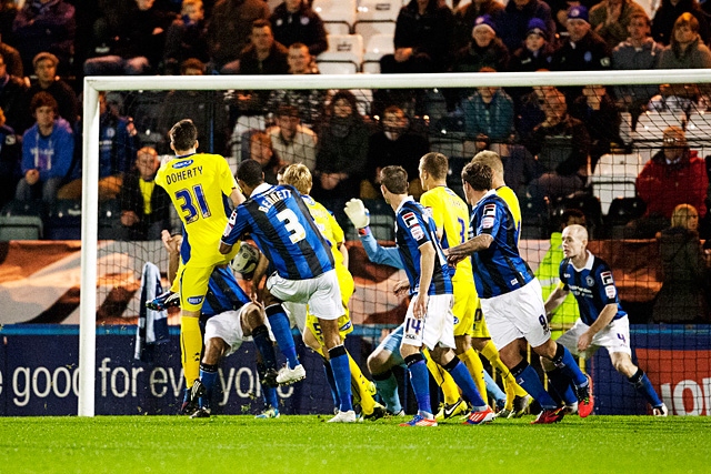 Phil Edwards handles the ball in the packed area to give Bury a penalty