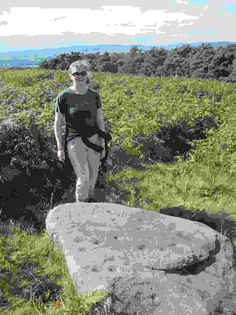 Louise Brown, Pennine Prospects community archaeologist, with the Barmishaw Stone on Ilkley Moor