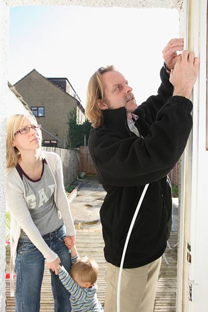 Energy Advisor installing draft excluders