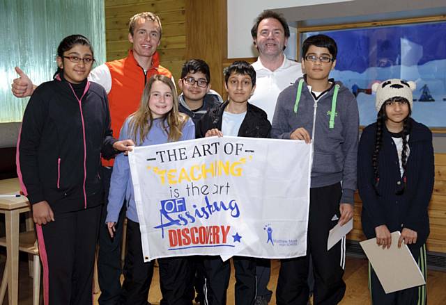 Students from Matthew Moss High School present Lee Houlding with their school flag at The Chill Factore, which will be displayed at base camp in Antarctica