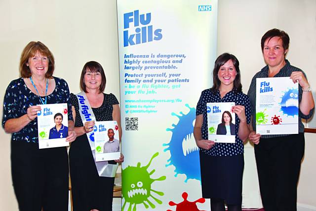 Staff at The Pennine Acute Trust’s Occupational Health Department with Flu campaign material