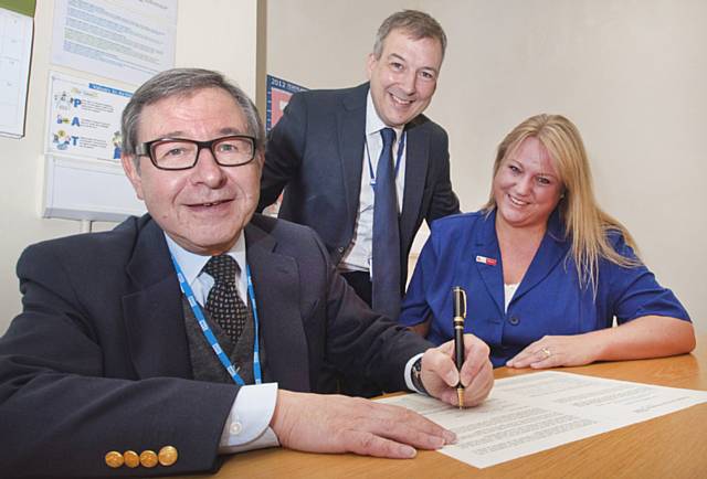 Trust Chairman John Jesky signing the Charter with Roger Pickering, director of human resources and Joanne Heyworth, Staff Side’s Deputy Secretary for The Pennine Acute Hospitals NHS Trust