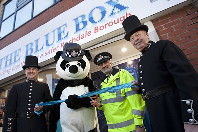 Retired police officers Mike McCulloch ( left) and  Tom Hughes (right) who are both retired GMP officers that volunteer to show groups around GMP Museum at the official opening of The Blue Box in Rochdale town centre with GMP mascot Pippa the Panda and Chief Inspector Nadeem Mir