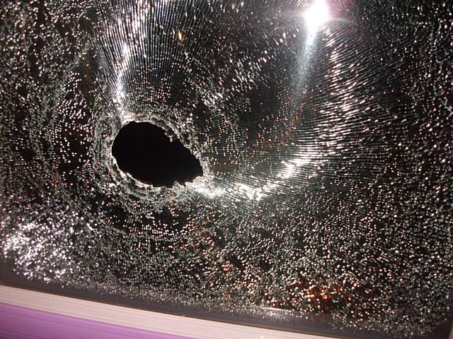 Damage caused to the bus when the stone was thrown through the window and hit the passenger