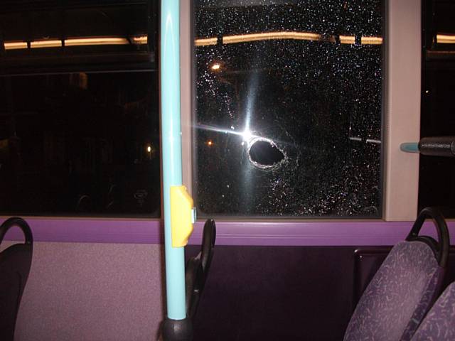 Damage caused to the bus when the stone was thrown through the window and hit the passenger.