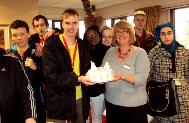 The group of students with the cake