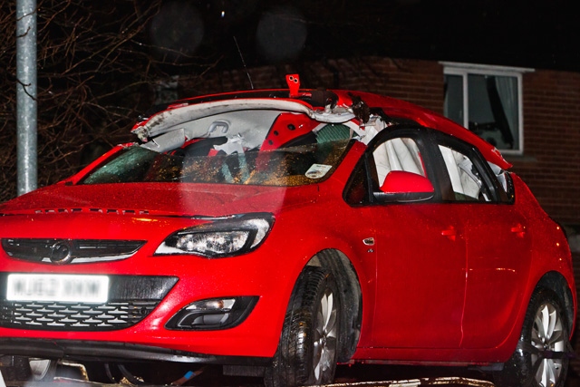 The fire brigade cut the roof off the car to safely remove one of the occupants who has back and neck injuries