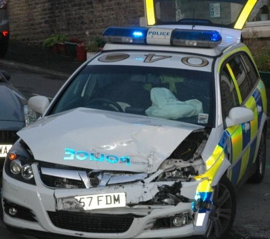 The damaged police car at the scene of the collision 
