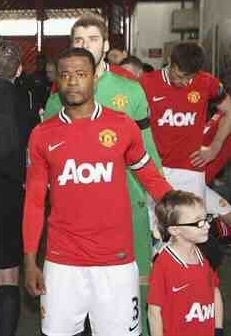 Harry, 8, with United's Patrice Evra