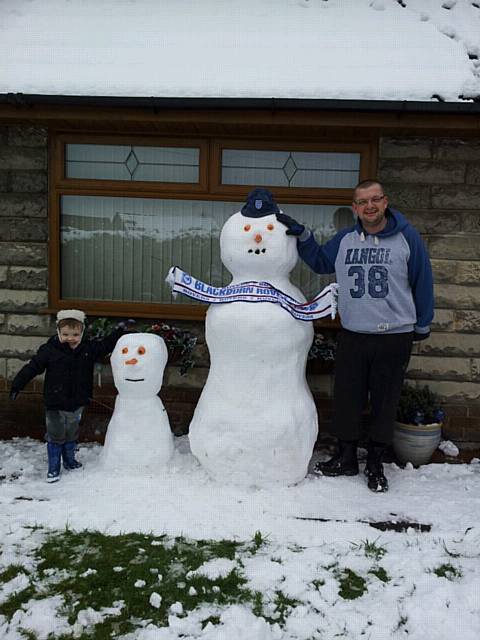 George Stewart, 2, with Dad, Mick Stewart, and their snowmen in Norden.