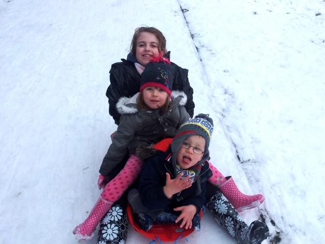 Molly, 11, Lauren, 4, and Joe, 4 sledging in Castleton. Photograph sent by Richard Murrie.