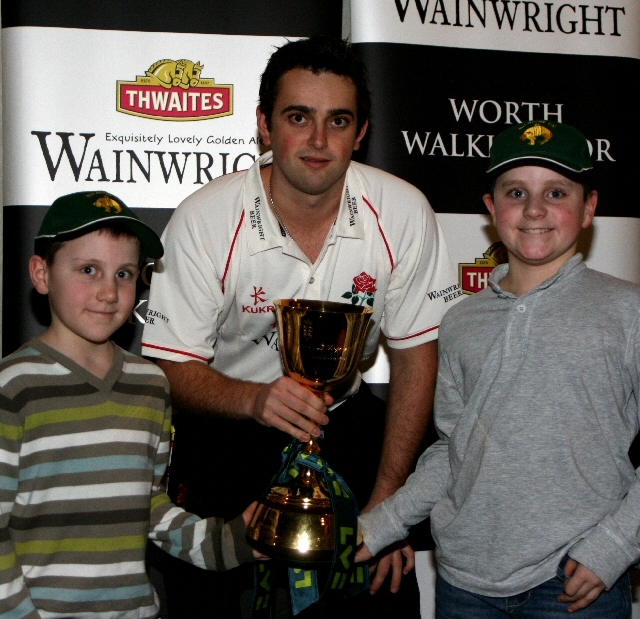 Young cricket fans with Stephen Parry and the County Championship Trophy