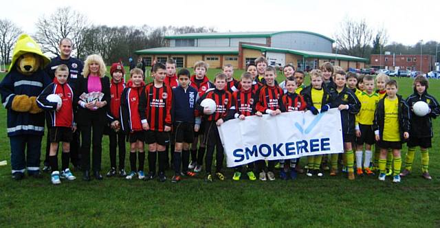 Pennine Junior Under 11s players with Ve Nutter, Health Improvement Officer at Rochdale Borough Council, and Blaze Bear, the Fire Brigade Mascot