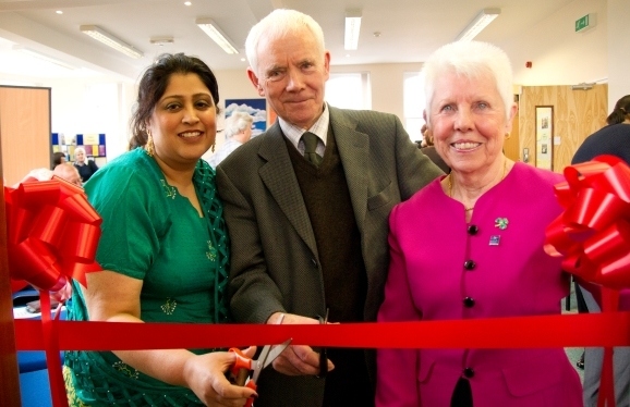 Eddie Coan (middle), previous chair of The Carers Association cuts the ribbon to officially open Newbold, with Pauline Fardon (right), current chair of The Carers Association and carer Noreen Akthar (left).