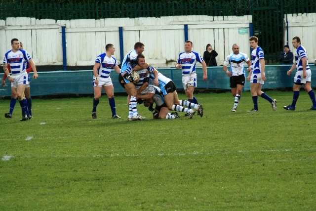 Ieuan Higgs feels the force of the hunslet defence