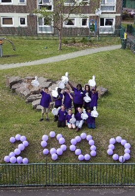 The RBH Junior Wardens, a youth based community project at Lower Falinge help spell out the 2000 member message