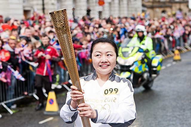 Wensheng Li arrives in Rochdale Town Centre with the Olympic Flame