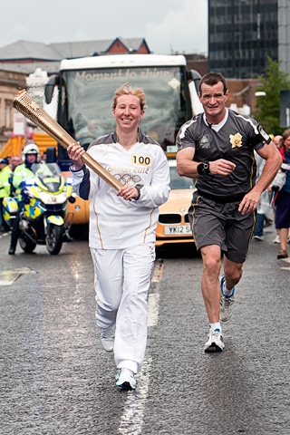 Amy Peckover leaves Rochdale Town Centre with the Olympic Flame