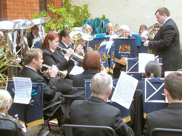 Blackley Band playing at the front of Veenas Restaurant.