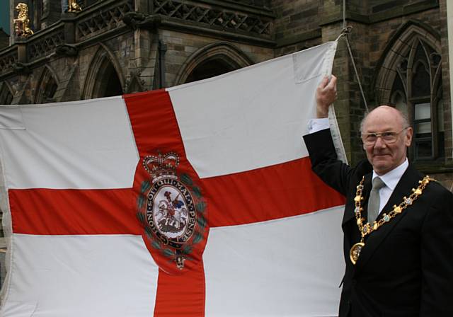 The Mayor of the Borough of Rochdale, Councillor James Gartside, prepares to raise the flag by Rochdale Town Hall
