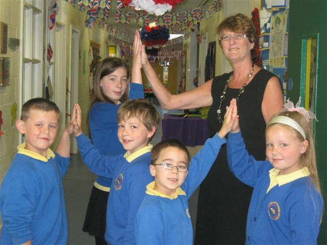 Elaine Hibbert and pupils from Hollin Primary School in Middleton celebrate their outstanding Ofsted report