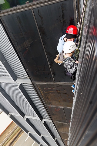 Adam Kutereba abseiling down the 230 foot black box encouraged by Mark Bland