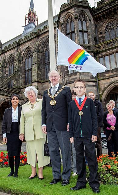 The Mayor and Mayoress accompanied by Sana Khan and Lewis Threlfall at the flag-raising ceremony, with some of the Heritage Walk participants in the background 
