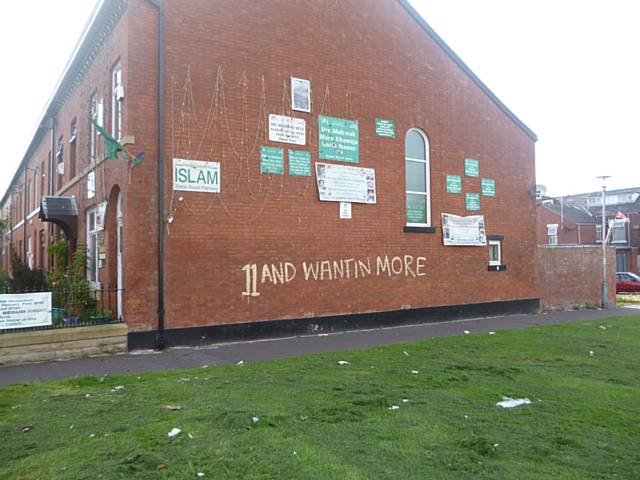 Graffiti along the side of the terraced house on King Street South, Rochdale