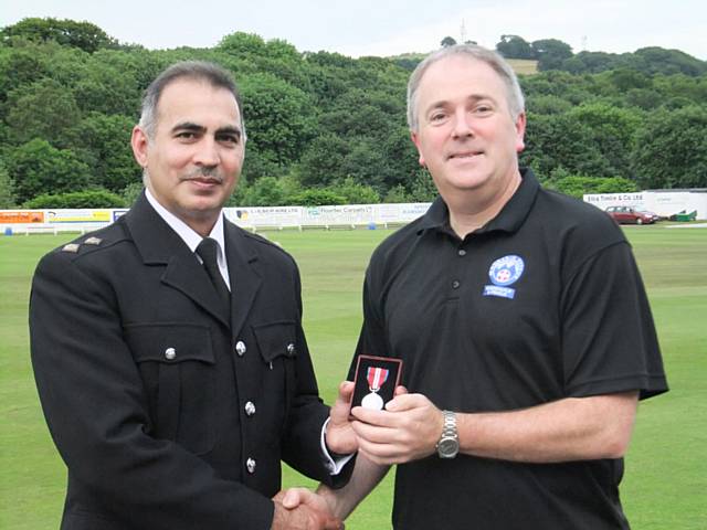 Mike King presented long term service award by Asrar Ul-Haq, Hub Commander from Rochdale Police