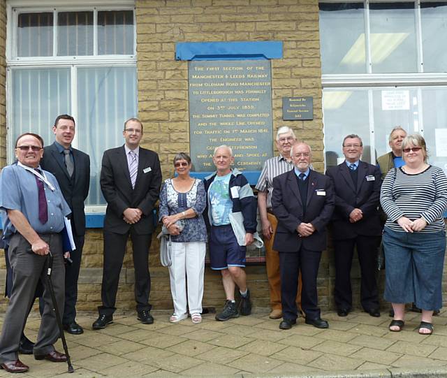 Guests and Northern Rail station staff in front of the plaque