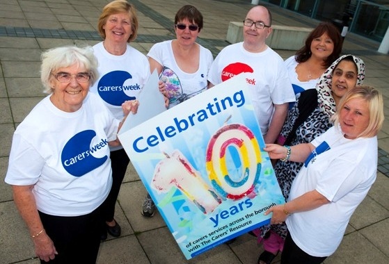 Carers sign the anniversary card to mark 10 years of carers’ services
