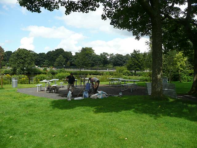 The picnic tables, with unimpeded views over the mere and across the park