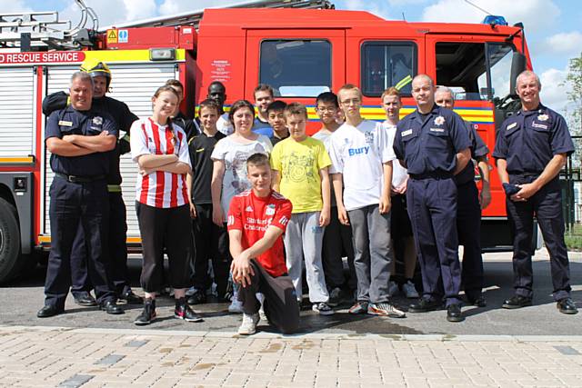 Nathan Milner (in red), with members of the local fire crew and the young people who participated in the workshop
