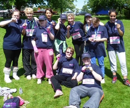 Race for life group enjoy some sun after their run
