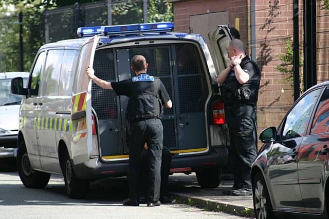 Suspected shoplifters in the back of the Police van
