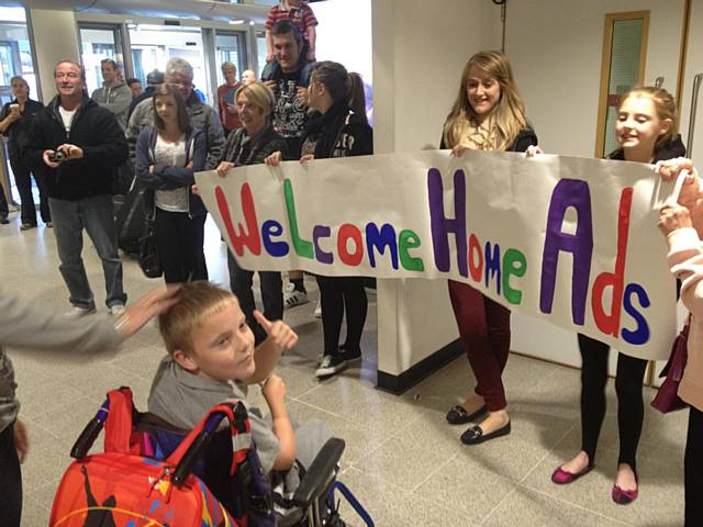 Adam Kutereba is greeted by family and friends on his return from America