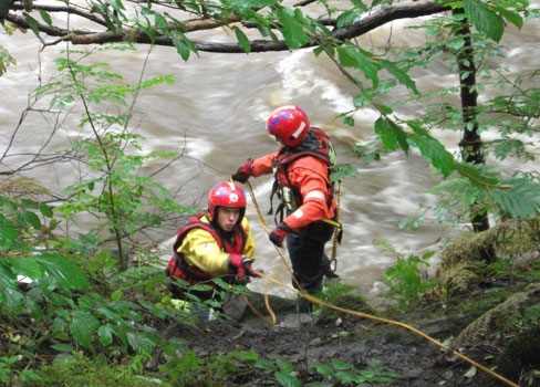 Firefighters from Heywood Fire Station help rescue the man in trouble on the River Irwell