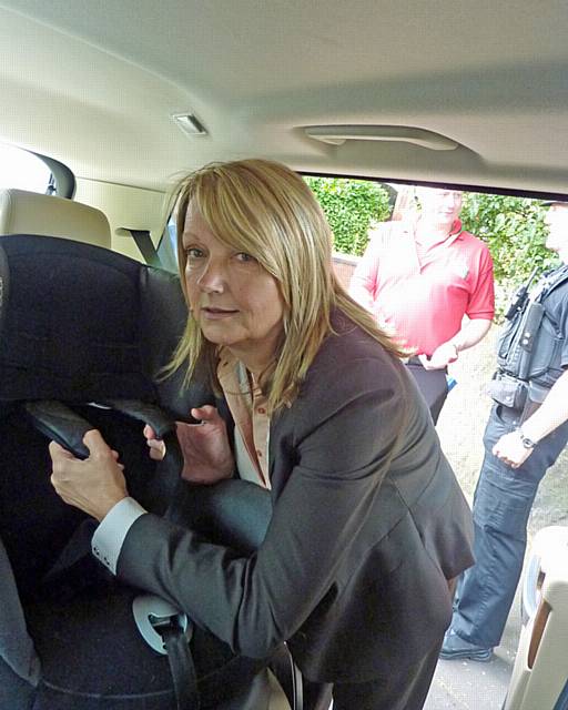 Casualty Reduction Community Liaison Officer Jacqui Hogg fits a child’s car seat in Milkstone, supported by colleagues and officers from Greater Manchester Police