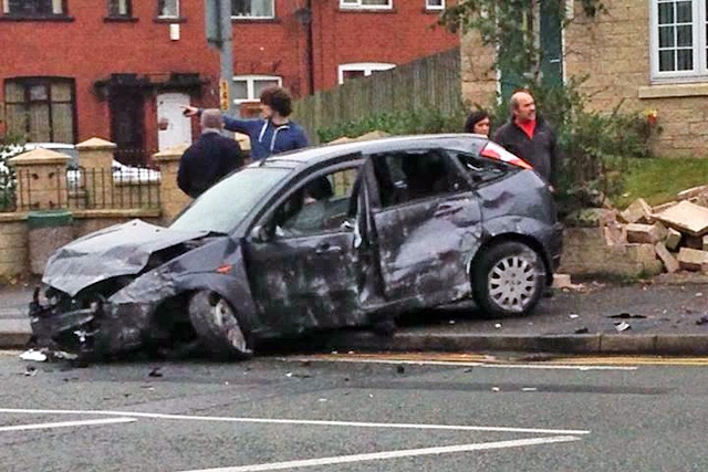 The badly damaged stolen car and demolished garden wall