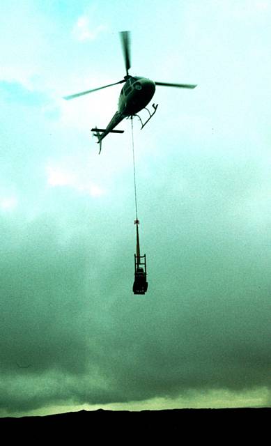 A helicopter flies in the flagstones onto the Pennine Way
