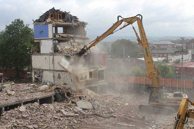 Contractors Casey demolishing Cartmel and Frieston blocks in Lower Falinge, ready to build 30 new homes