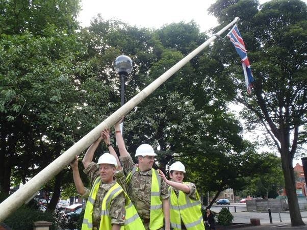 Soldiers from 202 Field Squadron Royal Engineers, based in Failsworth relocate the town’s flagpoles into Heywood memorial gardens
