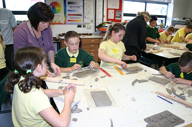 Pupils from Woodland school sample the delights of using Clay to make name plaques and a range of pinch and coil pots