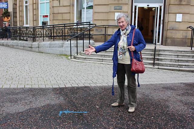 Margaret Royds looking at the markers on The Butts which sketch out where the river will be exposed
