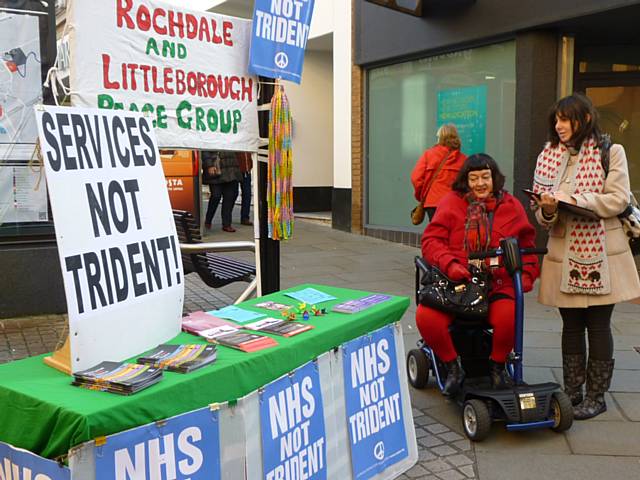 Wendy Knowles and Heather Inci signing the Peace Group letter at the stall 
