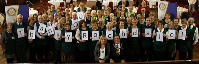 The Rotary Club of Rochdale, The Well Community Church, Mayor Councillor Peter Rush and Mayoress Monica Rush, Councillor Colin Lambert, Councillor Ashley Dearnely, Chair of the trustees, Iain Wight and some of the 80 friends of the foodbank say '55 tonnes of thanks from the Foodbank'