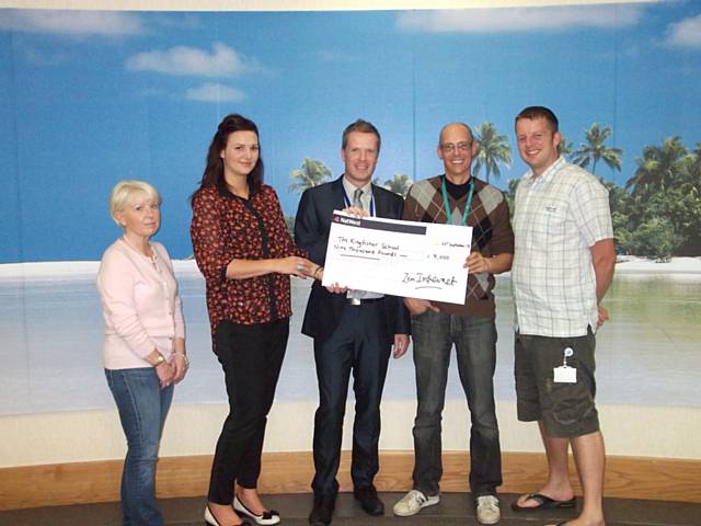 Michael Unsworth receiving the cheque from the Zen team