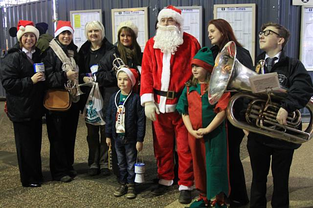 Santa posing with some helpers